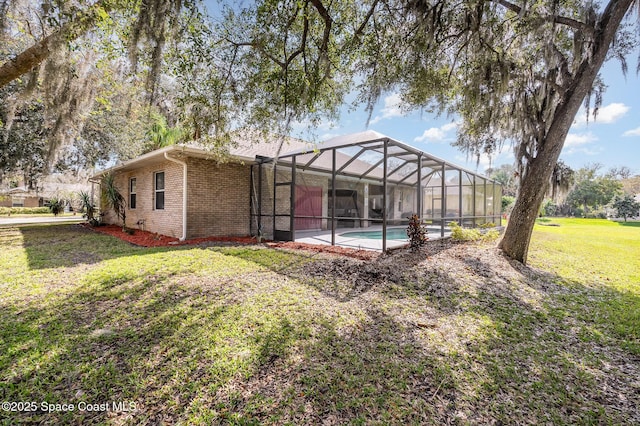 view of yard with a lanai and a patio area