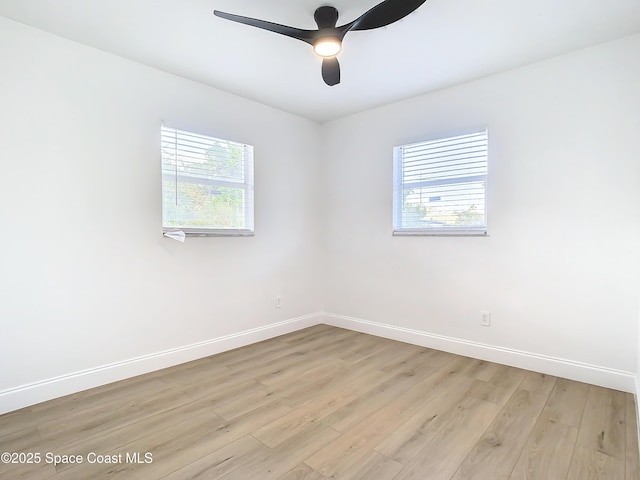 spare room featuring ceiling fan, plenty of natural light, and light wood-type flooring