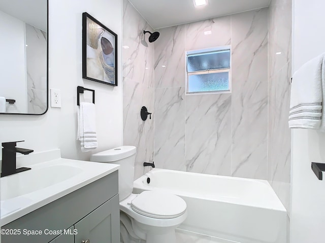 full bathroom featuring tiled shower / bath, vanity, and toilet