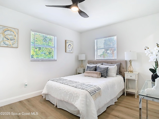 bedroom with ceiling fan and light wood-type flooring