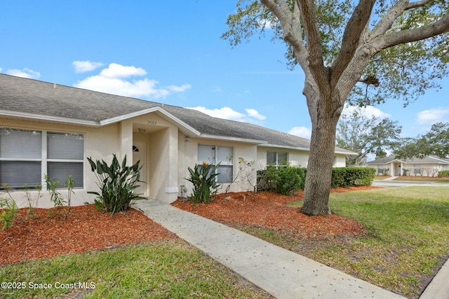 ranch-style house featuring a front lawn