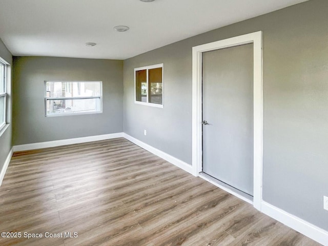 unfurnished bedroom with light wood-type flooring