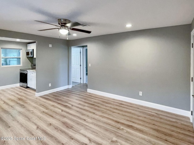 unfurnished living room featuring light hardwood / wood-style flooring and ceiling fan