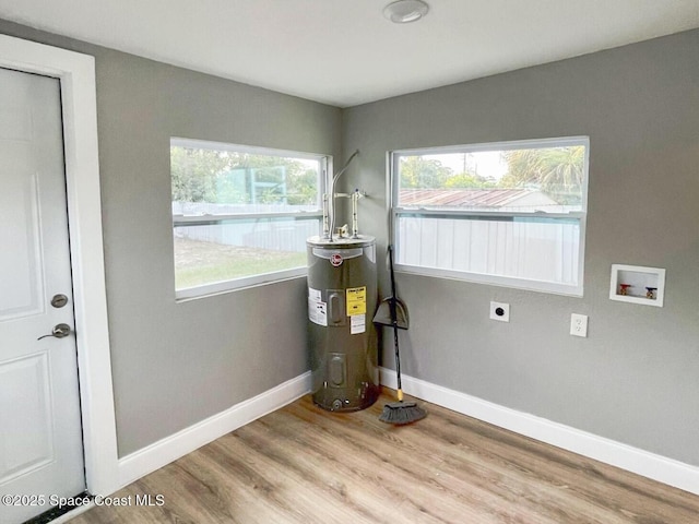 washroom with water heater, electric dryer hookup, hookup for a washing machine, and light hardwood / wood-style floors