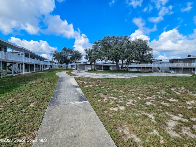 view of property's community with a lawn