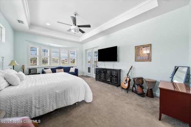 bedroom with a tray ceiling, light carpet, crown molding, and ceiling fan