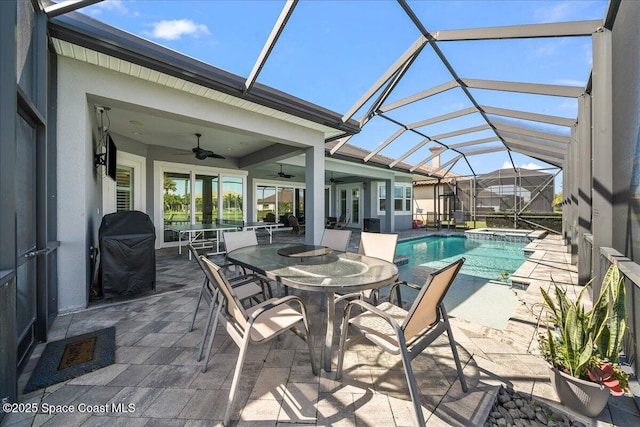 view of pool with a patio, area for grilling, an in ground hot tub, a lanai, and ceiling fan