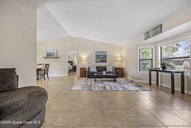 living room featuring vaulted ceiling and light tile patterned floors