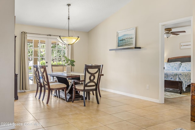 tiled dining space with lofted ceiling and ceiling fan