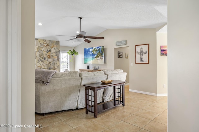 living room with vaulted ceiling, light tile patterned floors, a textured ceiling, and ceiling fan