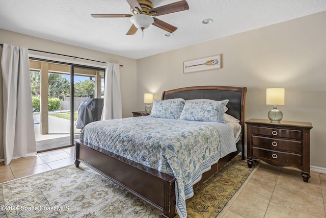 tiled bedroom featuring access to exterior, a textured ceiling, and ceiling fan