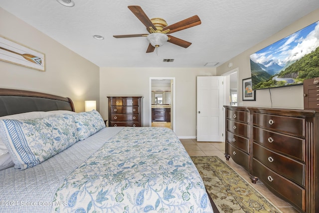 bedroom with light tile patterned floors, a textured ceiling, and ceiling fan