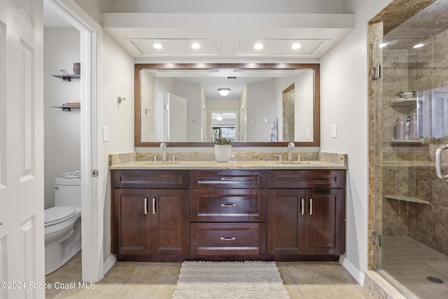 bathroom featuring walk in shower, vanity, toilet, and tile patterned flooring