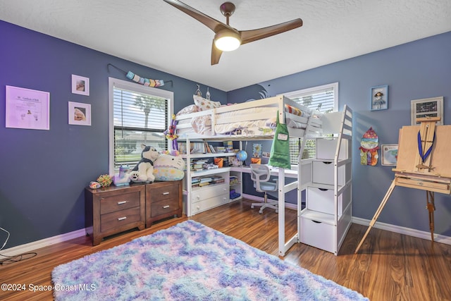 bedroom featuring dark wood-type flooring and a textured ceiling