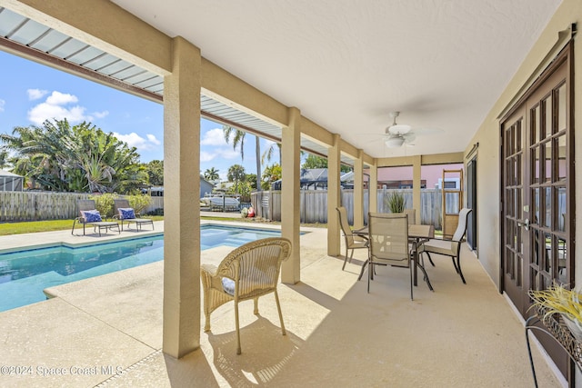 view of patio / terrace featuring ceiling fan and a fenced in pool