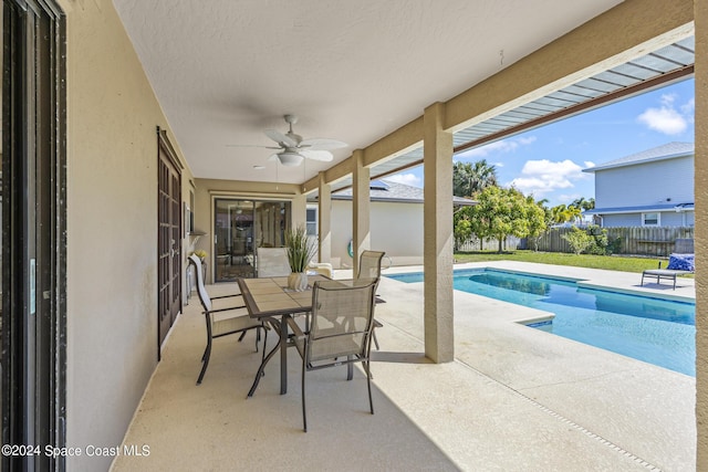 view of patio / terrace featuring a fenced in pool and ceiling fan