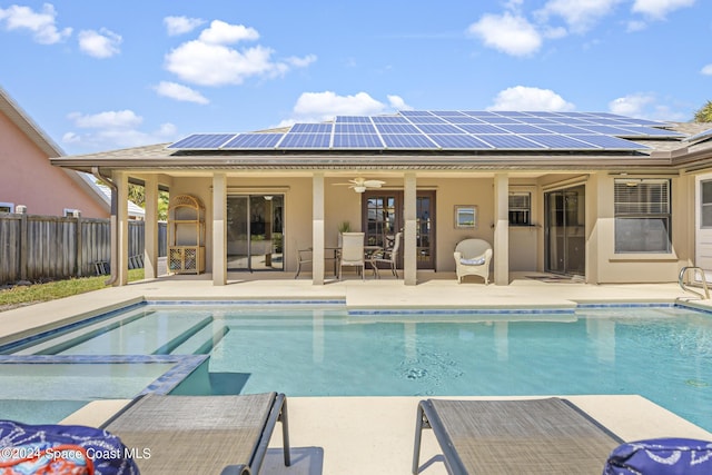 view of swimming pool featuring ceiling fan and a patio area