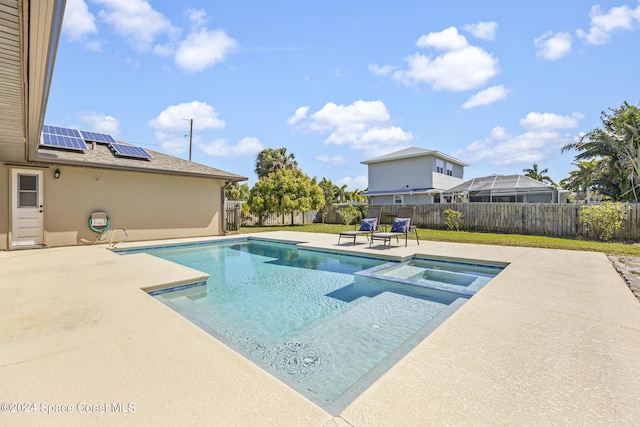 view of pool with a patio area and an in ground hot tub