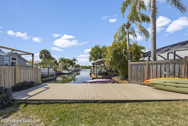 wooden deck featuring a water view and a boat dock