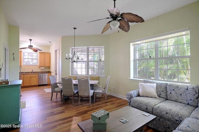 7831 Winona Rd, Melbourne Beach, FL 32951 - living area with a ceiling fan, a chandelier, and wood finished floors