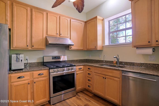 7831 Winona Rd, Melbourne Beach, FL 32951 - kitchen featuring appliances with stainless steel finishes, under cabinet range hood, ceiling fan, light wood-style flooring, and light brown cabinets