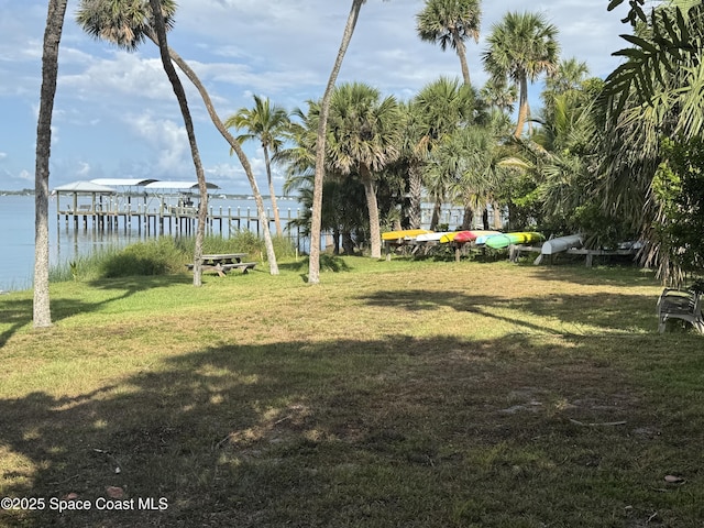 7831 Winona Rd, Melbourne Beach, FL 32951 - view of green lawn featuring a water view