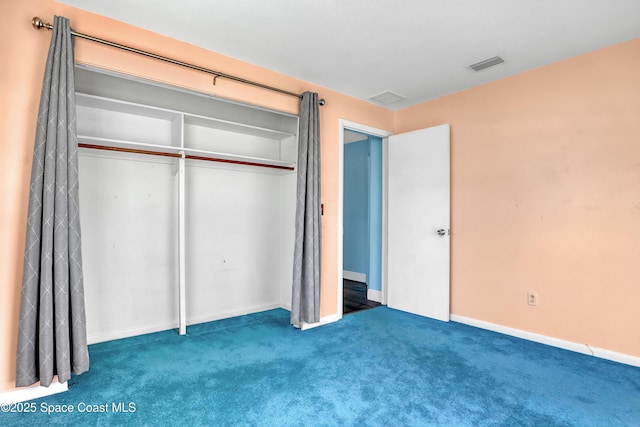 unfurnished bedroom featuring carpet flooring and a closet