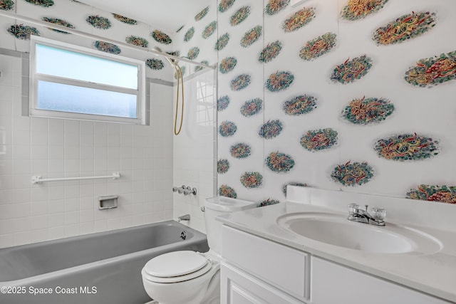 full bathroom with vanity, tiled shower / bath combo, and toilet