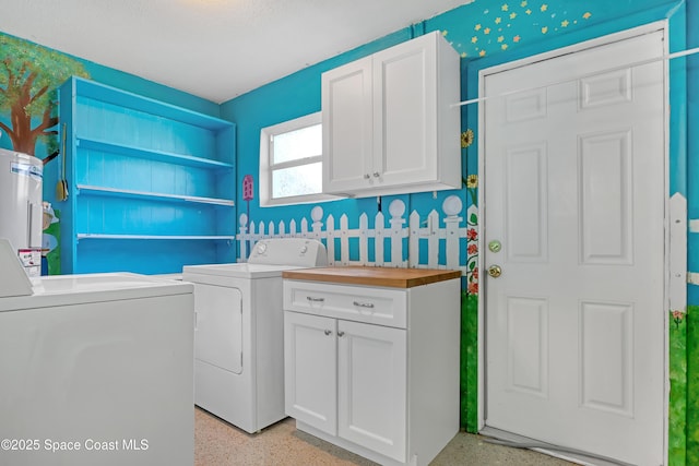 clothes washing area with cabinets, separate washer and dryer, and water heater