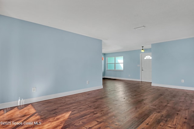 unfurnished living room with dark hardwood / wood-style flooring