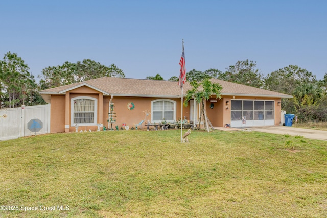 ranch-style house featuring a garage and a front yard