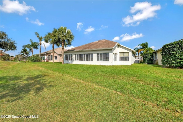 rear view of property with a yard