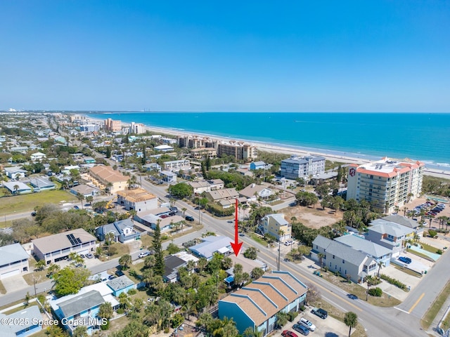 drone / aerial view with a beach view and a water view