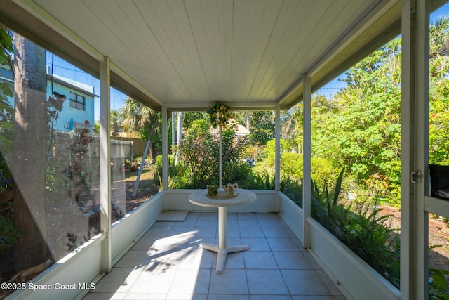 unfurnished sunroom featuring plenty of natural light and wood ceiling