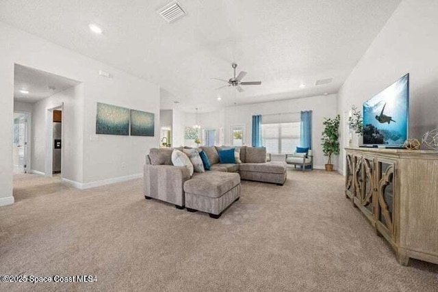 carpeted living room featuring ceiling fan and a textured ceiling