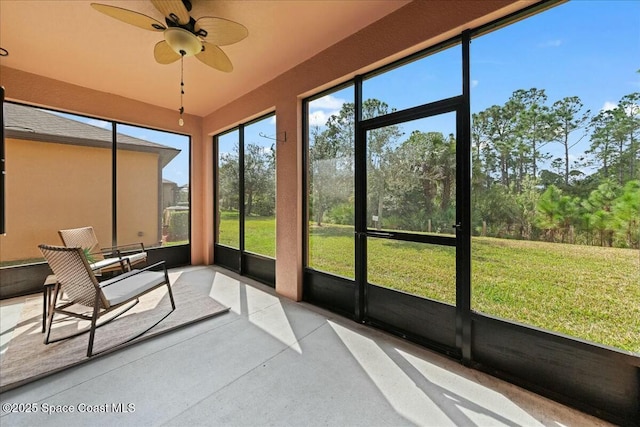 unfurnished sunroom featuring ceiling fan
