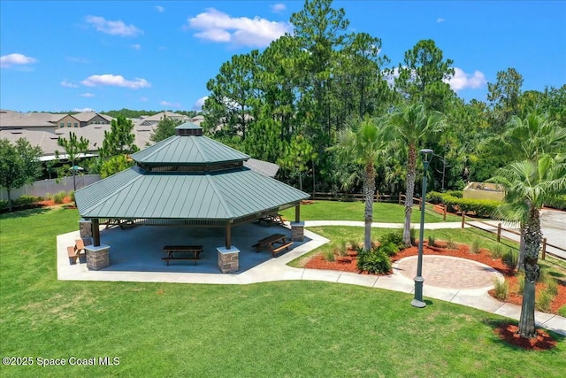 view of home's community with a gazebo, a patio area, fence, and a lawn