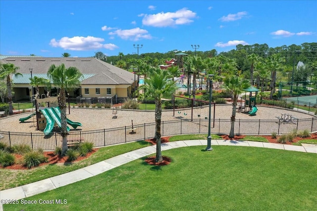 communal playground with fence and a lawn