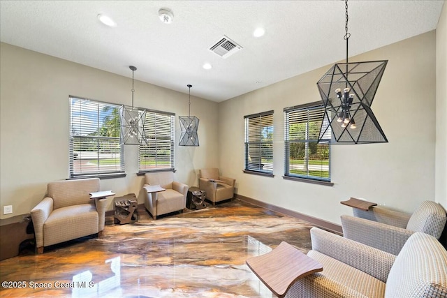 living area featuring visible vents, baseboards, recessed lighting, and a textured ceiling