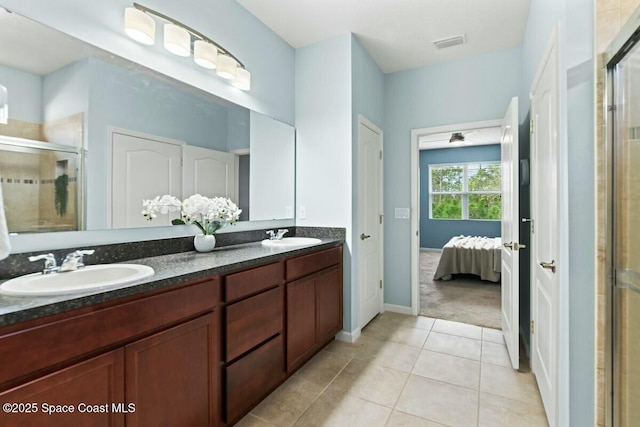 bathroom with a shower stall, tile patterned flooring, visible vents, and a sink