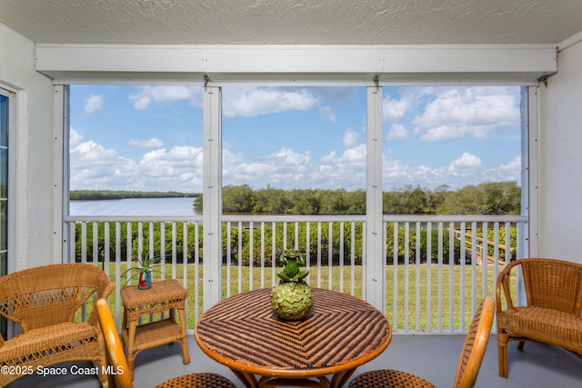 sunroom / solarium with a water view