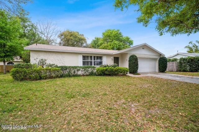 single story home featuring stucco siding, fence, concrete driveway, a front yard, and a garage