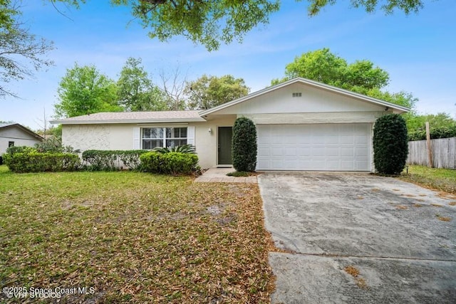 ranch-style home featuring fence, an attached garage, stucco siding, concrete driveway, and a front lawn