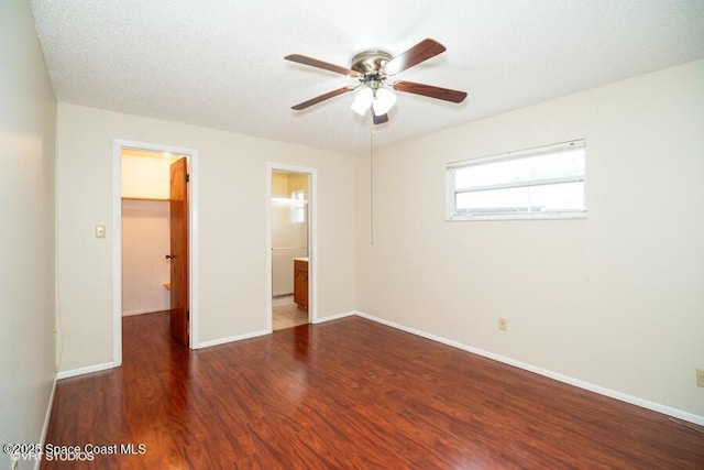 unfurnished room with a ceiling fan, baseboards, and wood finished floors