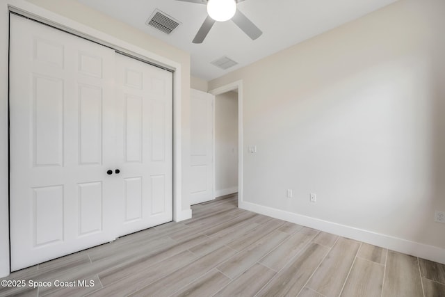 unfurnished bedroom with ceiling fan and a closet