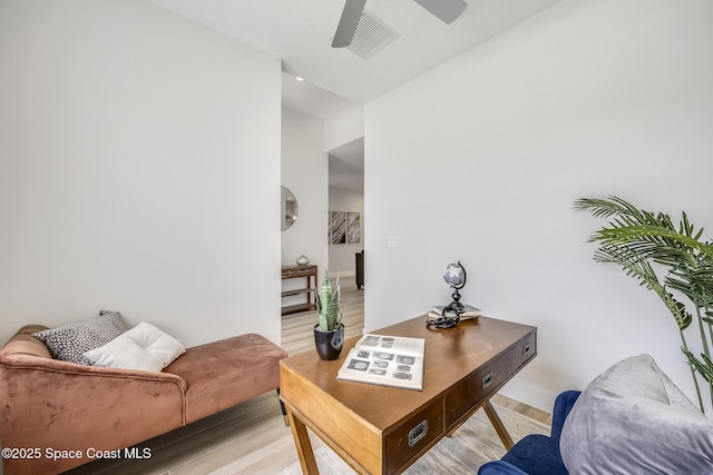 living room featuring ceiling fan and light hardwood / wood-style flooring