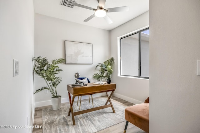 office space featuring ceiling fan and light wood-type flooring