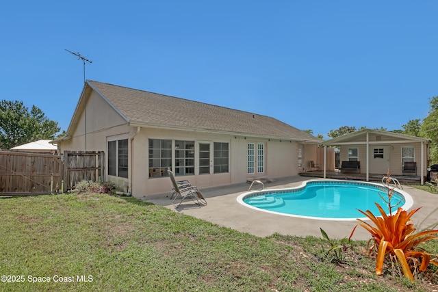 view of swimming pool featuring a patio and a lawn