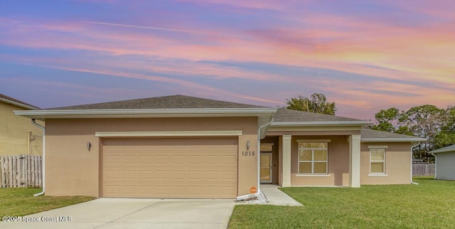 prairie-style home with a garage and a lawn