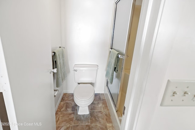 11 Plantation Dr Unit 201, Vero Beach, FL 32966 - bathroom featuring a shower with shower door and toilet